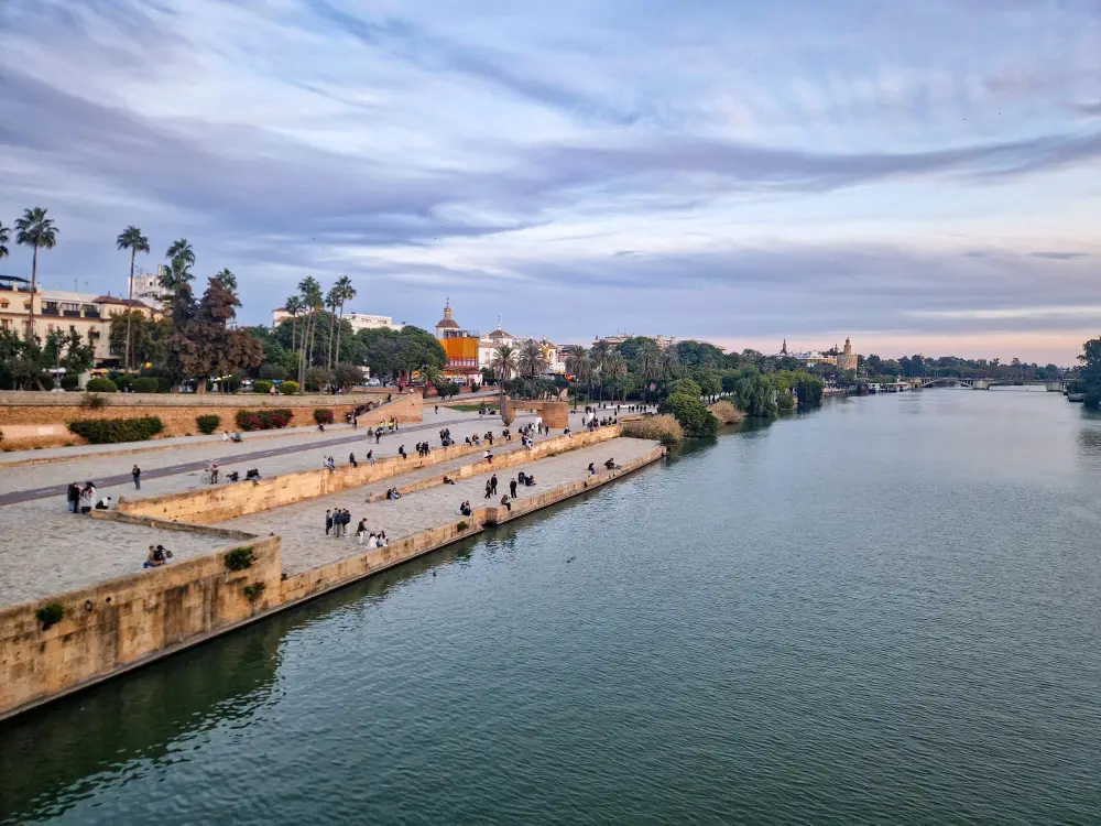 Rio Guadalquivir com marginal de Sevilha e Torre del Oro ao fundo.